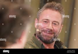 Hamburg, Germany. 17th Jan, 2022. Singer and musician Sasha speaks during  the musical reading of his first book "If You Believe