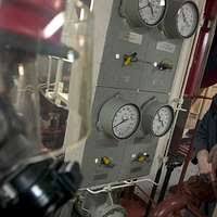 Engineman 1st Class Daniel Citizen from Lafayette, La., front, and  Engineman 2nd Class David Larson, from Bigelow, Ark., prepare the main  machinery room number 2 operating station for an operational test. -