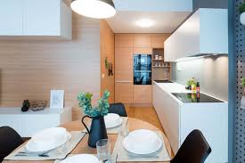 The dining table placed perpendicular to sofas helps define a separate dining area and creates a buffer between the kitchen and living room. Six Tips For A Comfortable Dining Room