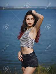 Sexy, Cute Young Girl Touching Her Hair. A Teenager On A Blurred River  Background. Beauty And Style Concept. Copy Space. Stock Photo, Picture and  Royalty Free Image. Image 85253398.