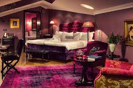 The warm gray throw and velvet black pillows stand in stark contrast against white beddings, while the addition of ultra stylish furniture pieces like the mirrored tables and frames all make this bedroom appear classy and luxurious. 10 Most Romantic Bedroom Designs For Couples