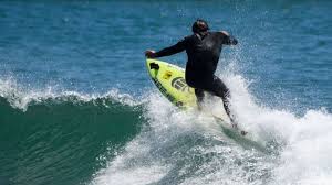 .four surfers paddled out into the pacific for the start of the games' very first surfing competition. 01pfmtq4czc84m