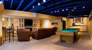 Decor Includes Industrial Style Furniture From Restoration Hardware Track Lighting Check Out Our 20 Basement Lighting Exposed Basement Ceiling Basement Design