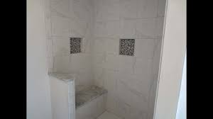 This tiled shower bench uses dark ceramic tiles instead of the usual light colored tiles, giving it a unique, contemporary appeal. Tile Shower Stall Installation Waterproofing Bench Seat Wall Tile Noble Niche And More Youtube