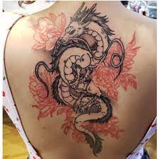 Dragon flower tattoos the dragon flower is a delicate plant with mysterious origins. Back Tattoo Of Dragon And Flowers Red Ink Tattoos Dragon Tattoo Shoulder Leg Tattoos