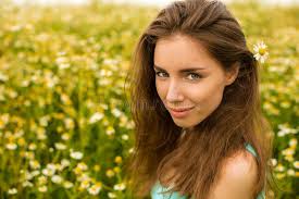 Photo of Pretty Brunette Woman in Chamomile Field Stock Photo