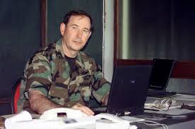 Right side front view medium close-up from the waist up as Joint Special  Operations Task Force Commander, US AIr Force Colonel Michael Russell,  works