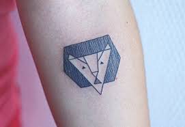 Tiny black tattoo on the collarbone. Small Lion Tattoo