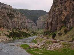Look for bighorn sheep and enjoy the sheer beauty of the wind river canyon's towering cliffs and vistas, then look out, here come the churning rapids such as reverend pugh, chimney rock, glassy wave, lone bear, freight train, washakie falls, and end of the trail. Wind River Canyon Wikipedia