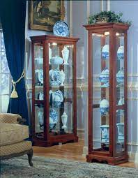 A short curio cabinet display case looks great in any room with a wall mirror above it. Small Curio Cabinet Cherry Small Solid Wood Curio Cabinet With Crown Molding Introduce A Timeless Display Piece F Small Curio Cabinet Curio Cabinet Cabinet
