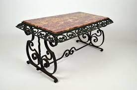 The forged steel base was created using a forge to heat the steel Art Deco Style Wrought Iron Coffee Table With Marble Top 1940s For Sale At Pamono