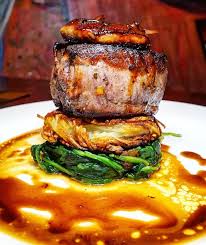 Delmonico S Tournedos Rossini Filet Mignon Plated Over A Bed Of Potato Pancake And Sauteed Spinach Then Dressed I Filet Mignon Potato Pancakes Sauteed Spinach