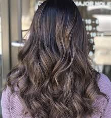 Dark brown hair tumbles over the shoulders in thick waves while a gentle touch of gold subtly shades a front strand in this hair color idea. 70 Brilliant Brown Hair With Blonde Highlights Ideas