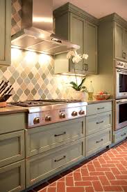 Designer Bria Hammel Warms Up This Classic Kitchen And Adjacent Dining Room With Earthy T Green Kitchen Cabinets Kitchen Inspiration Design Brick Floor Kitchen