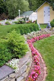 Stone Wall With Pink Flowering Wax Begonias Iberis Atop Stone Wall Evergreen Shrubs Bux Landscaping Retaining Walls Backyard Landscaping Beautiful Backyards