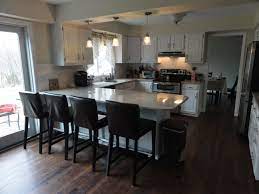 U shaped kitchen remodel with island. Lovable White Wooden And Glossy Marble Top Kitchen Island With Seating And U Shaped White Kitch Kitchen Layout Kitchen Remodeling Projects Kitchen Remodel Cost