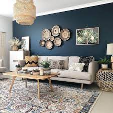 A Dark Blue Accent Wall With Cream Colored Sofa Wicker Basket Baskets And A Accent Walls In Living Room Living Room Wall Color Blue Living Room