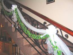 You may incorporate tulle into your wedding decor in multiple ways, for example, make an arch covered with tulle or with tulle curtains hanging down and decorated with some greenery and blooms. Image Detail For Stairs Decoration Stairs Decoration With Tulle Garland And Bows Go Stair Decor Staircase Decor Wedding Stairs