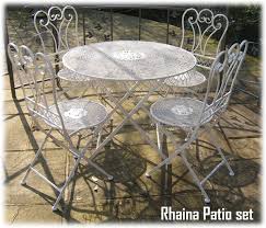 Gorgeous top quality 3 piece, wrought iron patio suite comprising of two beautifully decorated chairs finished in a antiqued cream /off white lattice weave style, complemented by a matching 68cm's diameter table. Garden Furniture Wrought Iron Rhaian Patio Set With Folding Chair And Table