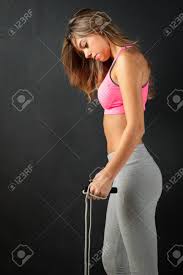 These ladies keep tearing up the gym. Attractive Female Fitness Model Isolated On A Black Background Stock Photo Picture And Royalty Free Image Image 57975878