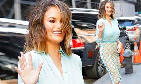 Chrissy Teigen puts on a busty display in sheer blouse 