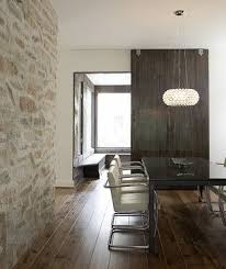 A pretty dining space feels bright and expansive with large windows and light stones. Concealed Sliding Door Hardware Stone Walls Interior Furniture Design Living Room Stone Wall Design