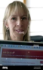 Dr. Delaney Kirk, professor of management at Drake University, shows a  website she manages at her home in Ankeny, Iowa,