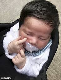 Baby girl is born with a marvellous head of thick black hair