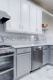 We Brought This Kitchen Up To Date By Painting The Existing Cabinets White On Top And A Kitchen Backsplash Trends Grey Kitchen Designs White Kitchen Backsplash