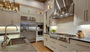 White Cabinet Kitchen With Stainless Steel Appliances Stainless Steel Appliances Give An Industria Farmhouse Interior Farmhouse Interior Design Kitchen Layout