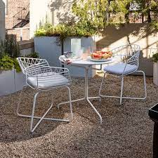 This set includes 2 armrest chairs, 1 coffee table, and 2 seat cushions. Soleil Metal Outdoor Bistro Dining Set Table 2 Chairs