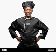 Young black cook wearing chef hat confident and happy with a big natural  smile laughing Stock Photo 