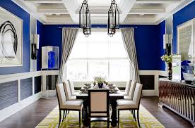 This dining room features a large area rug where the dining table and chairs are situated. How To Use Yellow To Shape A Refreshing Dining Room