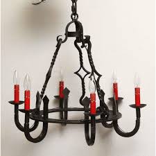 Round black wrought iron chandelier with bulbs weighs in summer house stock image image of design circle 167194759. Gothic Black Wrought Iron Chandelier With Red Candlesticks Chairish
