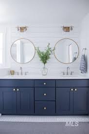 Grey and gold has been on the design scene for a few years now, and it doesn't seem to be going anywhere. White Blue Gold Bathrooms White Tile Flooring Walls And Sink Tops Dark Blue Vanity Doors And Drawe Bathrooms Remodel Bathroom Remodel Master House Bathroom