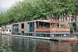 An Amsterdam Houseboat Features A Live In Kitchen House Boat Floating House Houseboat Living