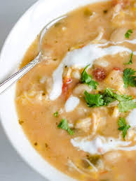 Add the beans, green chiles, garlic and chicken broth to the slow cooker and stir it all around. Close Up Birds Eye View Of Bowl Full Of White Chicken Chili Swirled With S Slow Cooker Chicken Chili White Chicken Chili Slow Cooker White Chili Chicken Recipe