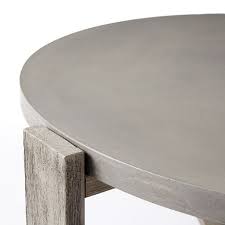 This coffee table is constructed from concrete, engineered wood, and metal. Concrete Outdoor Coffee Table