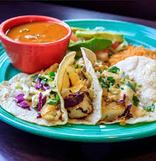 Two grilled fish tacos in soft corn tortillas. Our Delightful Fish Taco Plate Las Palapas Restaurants Facebook
