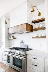 Reclaimed wood has become one of the hottest materials to try out in modern homes, and it is one trend that is only going to climb up the charts in the coming years with homeowners reclaimed wood accent wall and hood for the small, stylish kitchen [design: Pin On Kitchens