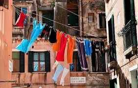 If you are wandering to keep the perfect color of clothes. Hd Wallpaper Hang Assorted Color Clothes At Daytime Clothes Hanged Between Buildings Wallpaper Flare