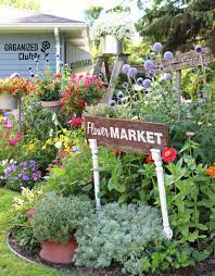 The Enchanting Garden Behind This House Gives The Word Junkyard New Meaning Funny Garden Signs Country Garden Decor Garden Junk