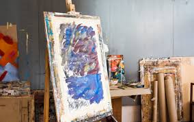 wooden easel with messy painting in artists workshop photo