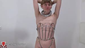 HOT! I am locked in the Iron Maiden Corset and in Reverse Rigid Fiddle!