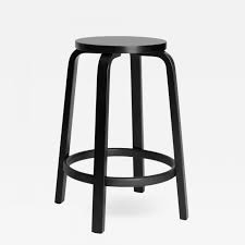 The chair features birch legs and a low back made of bent birch plywood. Artek Authentic High Stool 64 Counter Stool In Black By Alvar Aalto Artek