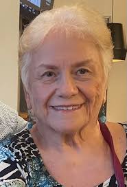 Can someone please make this sweet girl smile and place a pretty background  and remove the bags from the mother's hands. Thank you in advance