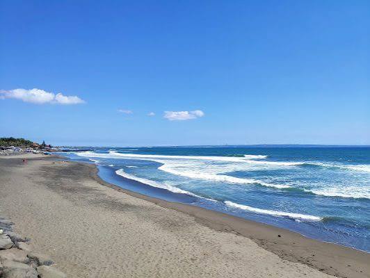 Echo Beach in Canggu, Bali — surfers and black sand at sunset
