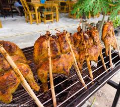 Four bamboo skewers are tied on both sides of the chicken with a piece of wire to assist in turning the birds while cooking. Thailand Street Food Gai Yang Look Inside Thailand