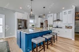 Designer lenore weiss used the wood extensively in this chicago kitchen, making it a cozy destination even during the most blustery of winter mornings. A Warm Kitchen With Center Table Stock Photo Picture And Royalty Free Image Image 148400639