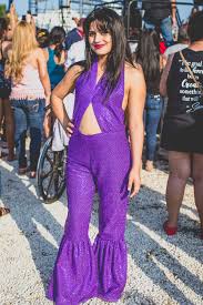 The purple jumpsuit features bell bottoms and rhinestone broches at the side of both knees and at the front of. The Cult Of Selena And The Fiesta De La Flor Festival Racked